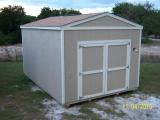 The Utility Shed in tan with white trim